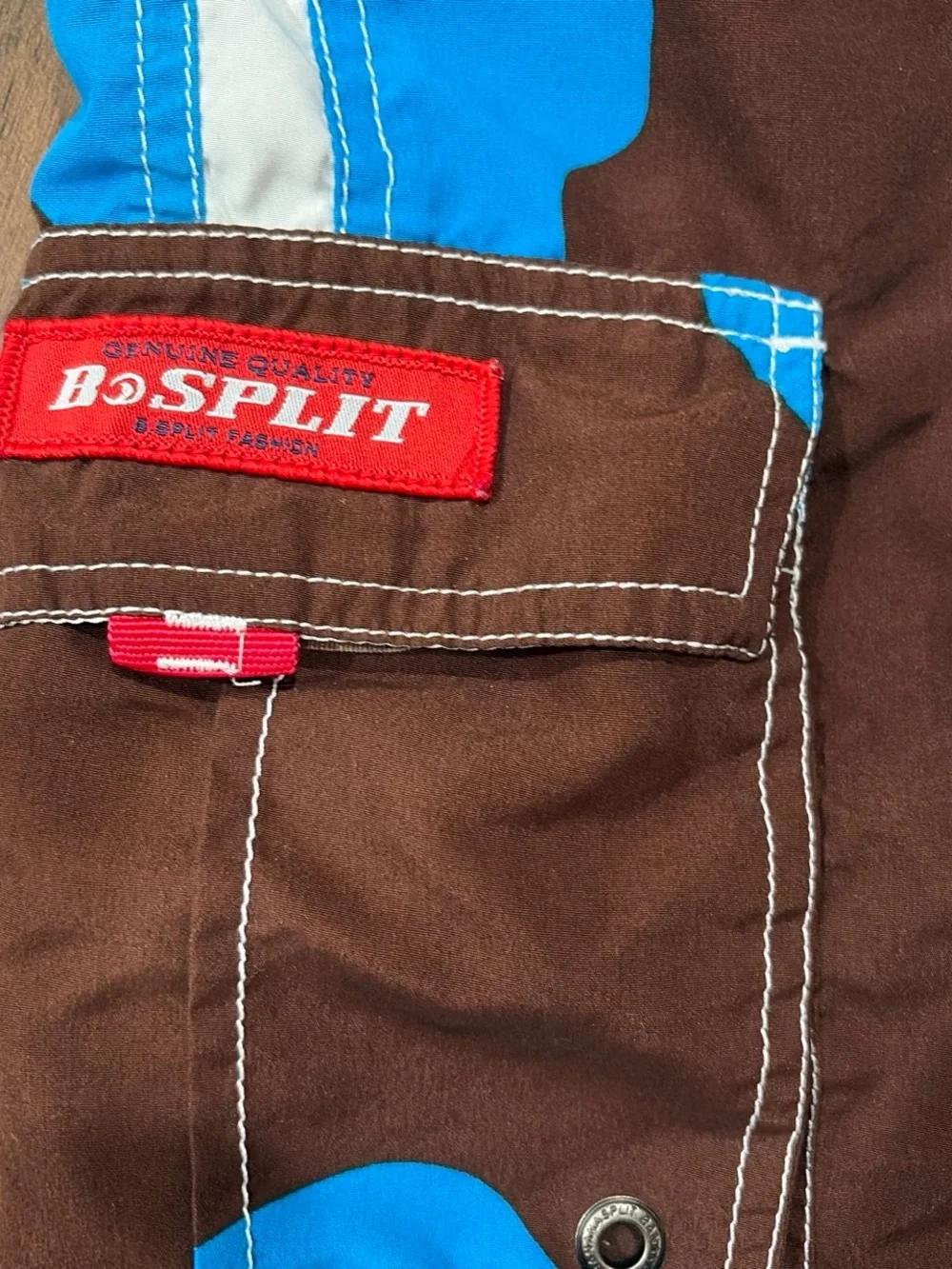 split Brown Swim Board Shorts with Blue Floral and Red Accents